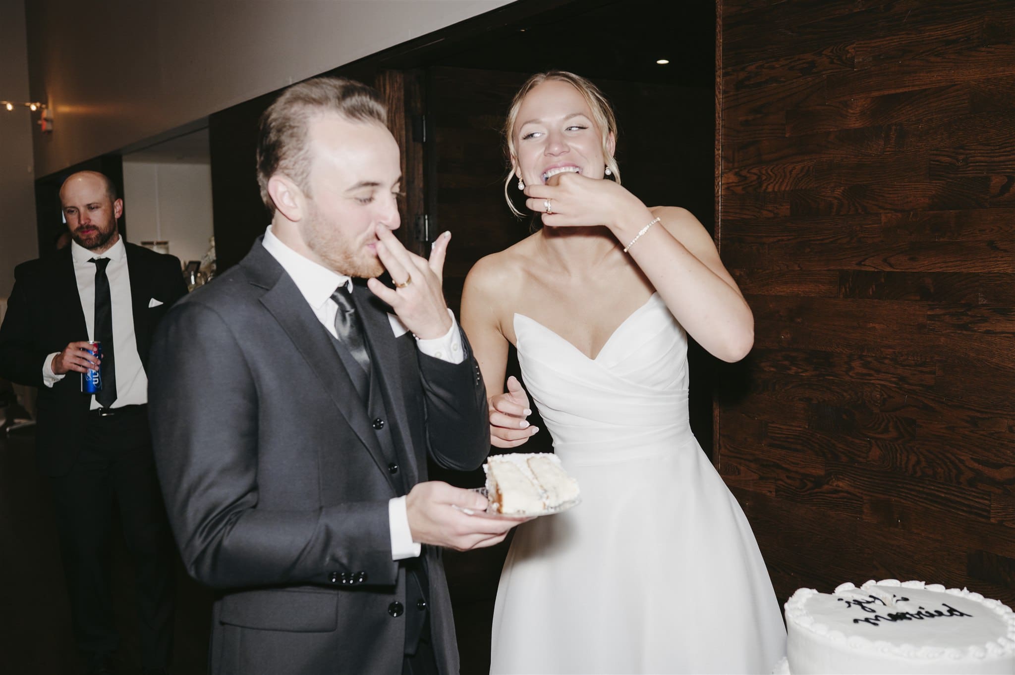 bride and groom eating cake on their wedding day