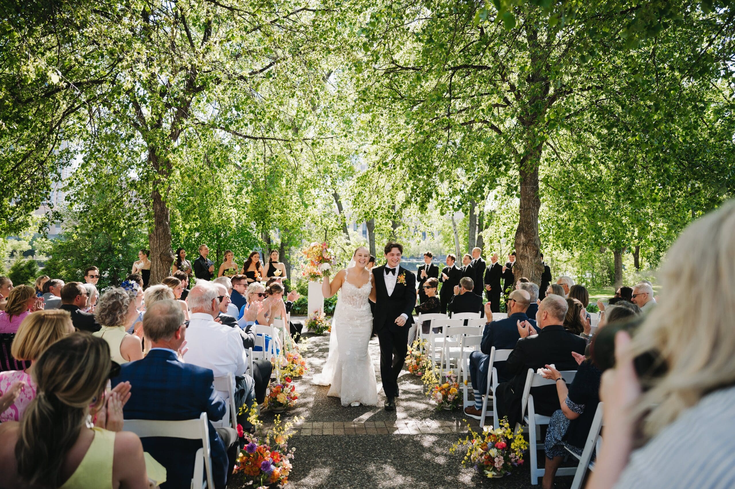 Candid wedding photo of the newlyweds celebrating at Nicollet Island Pavilion in Minneapolis.